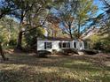 Charming ranch house with a white brick exterior, nestled amongst trees at 1814 N Druid Hills Ne Rd, Brookhaven, GA 30319