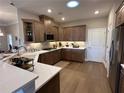 Modern kitchen with quartz countertops and wood cabinets at 1001 Calypso Way # 1001, Cumming, GA 30040