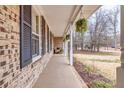 Covered front porch with brick columns and hanging planters at 2343 Meadow Dr, Snellville, GA 30078