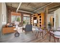 Open concept living and dining area with exposed brick and wood shelving at 3235 Roswell Ne Rd # 716, Atlanta, GA 30305