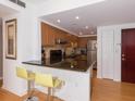 Modern kitchen with granite countertops, stainless steel appliances, and light wood cabinets at 199 14Th Ne St # 1209, Atlanta, GA 30309