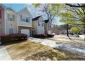 View of two story townhomes with attached garages, driveways, and manicured shrubs at 5665 Terremont Cir, Norcross, GA 30093