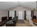 Spacious living room with vaulted ceiling, neutral decor, and ample natural light at 5863 Wintergreen Rd, Norcross, GA 30093