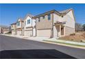 Row of townhomes featuring tan brick and light beige vinyl siding, each with a 2-car garage at 4101 Fulson Dr, Lilburn, GA 30047