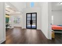 Bright and airy foyer with dark hardwood floors and modern black doors at 130 Wesley Place, Fayetteville, GA 30214