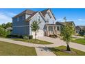 Side view of a two-story light blue house with a white garage door and landscaping at 1553 Brunswick St, Lithia Springs, GA 30122