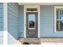 Inviting front entrance with a stylish gray door and well-maintained landscaping at 1553 Brunswick St, Lithia Springs, GA 30122