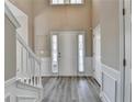 Bright foyer with hardwood flooring, high ceilings, and detailed trim at 355 Holland Springs Way, Powder Springs, GA 30127