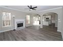 Open concept living room with kitchen view and fireplace at 355 Holland Springs Way, Powder Springs, GA 30127