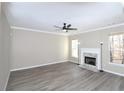 Spacious living room with fireplace and gray vinyl plank flooring at 355 Holland Springs Way, Powder Springs, GA 30127