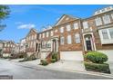 Row of townhouses showcasing attractive brick exteriors and landscaping at 5104 Leeshire Se Trl # 64, Atlanta, GA 30339