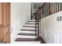 Elegant curved staircase with dark wood and wrought iron railing at 5104 Leeshire Se Trl # 64, Atlanta, GA 30339