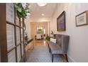 Inviting entryway with bench seating and hardwood floors; view of the dining room at 4703 Legacy Cove Ln, Smyrna, GA 30126