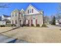 Brick two-story house with a large front yard and mature landscaping at 3473 Blanding Ct, Buford, GA 30519