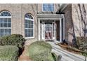 Brick facade with a double-door entry and landscaping at 3473 Blanding Ct, Buford, GA 30519