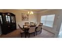 Formal dining room with a chandelier and large window at 6268 Odum Cir, Covington, GA 30014