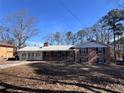 Brick ranch house with a spacious yard at 7480 Ambassador Dr, Riverdale, GA 30296