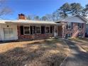 Brick ranch house with covered porch and landscaping at 7480 Ambassador Dr, Riverdale, GA 30296
