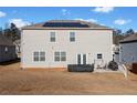 Backyard view featuring a patio, lawn, and solar panels on the roof of the house at 2527 Dayview Ln, Atlanta, GA 30331