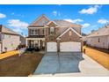 Beautiful two-story home boasts a spacious driveway, a two-car garage, and a charming front porch at 2527 Dayview Ln, Atlanta, GA 30331