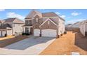 Two-story house with stone accents and a three-car garage at 2527 Dayview Ln, Atlanta, GA 30331