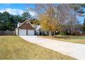 This home features a long driveway leading to a two-car garage and a stone facade at 117 Javay Ct, Villa Rica, GA 30180