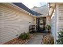 Inviting front entry with a black door, stone walkway, and landscaping at 117 Javay Ct, Villa Rica, GA 30180