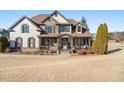 Two-story house with stone and shingle accents, and a wrap-around porch at 6610 Wesley Trail Holw, Cumming, GA 30028