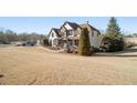 Two-story house with stone and shingle accents, and a wrap-around porch at 6610 Wesley Trail Holw, Cumming, GA 30028