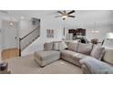 Spacious living room with a comfortable sectional sofa and access to kitchen at 11988 Lovejoy Crossing Pl, Hampton, GA 30228