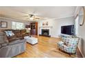 Bright living room featuring hardwood floors, a fireplace, and comfortable seating arrangements at 3536 Evans Ridge Trl, Atlanta, GA 30340