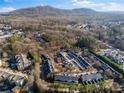 Aerial view of townhome community near wooded area and mountains at 1680 Perserverence Hill Nw Cir # 23, Kennesaw, GA 30152