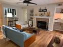 Cozy living room featuring a fireplace, modern furniture, and an open view to the kitchen at 2824 Vinings Central Se Dr # 146, Atlanta, GA 30339