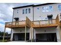 Townhomes showcasing large wooden decks and attached garages at 2524 Mountain Ash Se Ln # 108, Smyrna, GA 30080