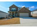 Two-story brick home with a large driveway and landscaped lawn at 309 Bowfin Trl, Mcdonough, GA 30253