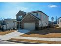 Two-story brick home with a large driveway and landscaped lawn at 309 Bowfin Trl, Mcdonough, GA 30253