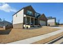 Two-story home with a side entry garage and landscaped yard at 309 Bowfin Trl, Mcdonough, GA 30253