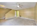 Spacious living room featuring neutral carpeting and a ceiling fan at 2878 Norfair Loop, Lithonia, GA 30038