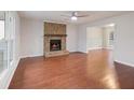 Spacious living room with hardwood floors, fireplace, and large windows at 2600 Sims Crest Ct, Snellville, GA 30078