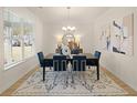 Contemporary dining room featuring a black wood table with blue chairs and modern artwork at 2712 Sw Riverpine Lot 175 Sw Trl, Atlanta, GA 30331