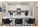 A modern kitchen features white cabinets, stainless steel appliances, and granite countertops at 2712 Sw Riverpine Lot 175 Sw Trl, Atlanta, GA 30331