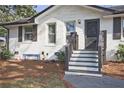 Inviting front entrance with freshly painted white brick and a cute blue bench at 2848 Monticello Pl, Decatur, GA 30030