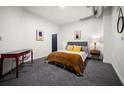 Second bedroom with a red desk, comfortable bed, and window at 260 18Th St # 10320, Atlanta, GA 30363