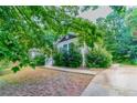 Home exterior showing manicured yard and driveway, surrounded by lush trees at 804 Thomasville Se Blvd, Atlanta, GA 30315