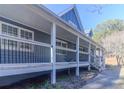 Side view of a gray house with a long wraparound porch at 1620 Palm St, Canton, GA 30115