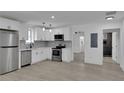 Modern white kitchen with stainless steel appliances and gray flooring at 1318 Graymont Sw Dr, Atlanta, GA 30310