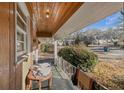 View of a covered porch with a wood ceiling, outdoor table, and railing at 1405 Pinehurst Sw Dr, Atlanta, GA 30311