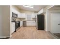 Bright kitchen features white cabinetry, stainless steel appliances, and hardwood floors at 16 Bromack Se Dr, Atlanta, GA 30315