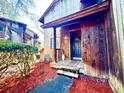 Inviting front entrance with a wooden porch and red mulch landscaping at 25 Quail Run, Decatur, GA 30035