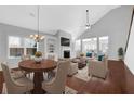 Open-concept living room with a fireplace, hardwood floors, and neutral decor at 3490 Buffington Ln, Cumming, GA 30040